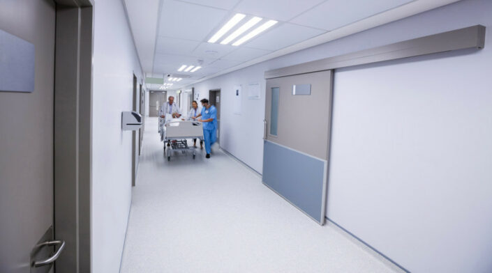 Team of doctors taking senior woman to the operation theatre in the corridor RightPatient-helps-iidentify-unknown-or-unconscious-patients