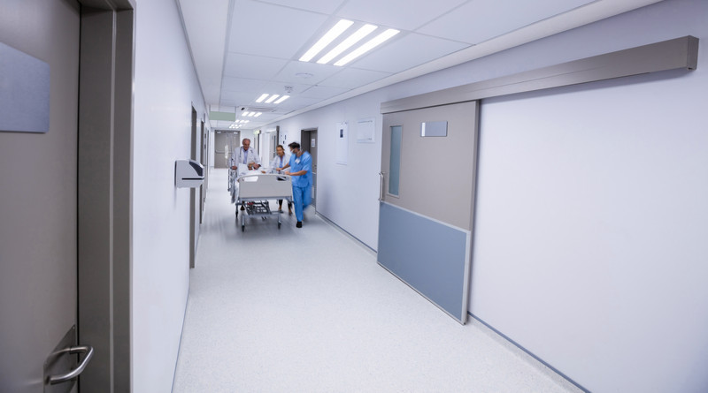 Team of doctors taking senior woman to the operation theatre in the corridor RightPatient-helps-iidentify-unknown-or-unconscious-patients