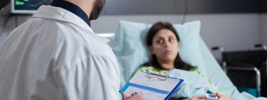 Specialist physician with stethoscope writing disease treatment on clipboard