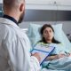 Specialist physician with stethoscope writing disease treatment on clipboard